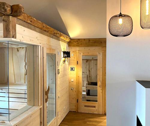a kitchen with wooden walls and a ceiling with a light fixture at Dachstein 7 in Gosau