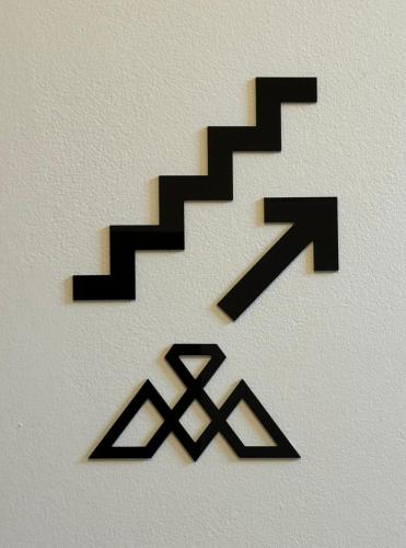 a group of black stairs on a white wall at Madi Luxury Stay Patra in Patra