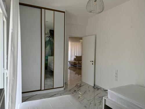 a bathroom with a large mirror and a room at Madi Luxury Stay Patra in Patra