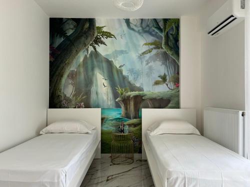 two beds in a room with a painting on the wall at Madi Luxury Stay Patra in Patra