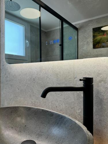 a bathroom with a sink and a mirror at Madi Luxury Stay Patra in Patra