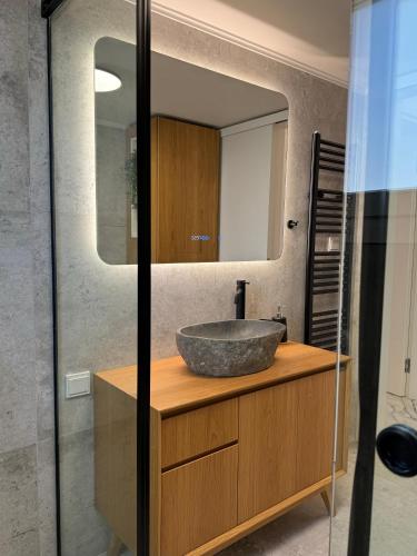 a bathroom with a sink and a mirror at Madi Luxury Stay Patra in Patra