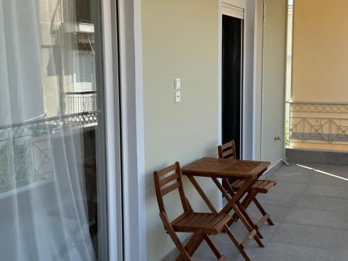 a table and two chairs sitting on a balcony at Madi Luxury Stay Patra in Patra