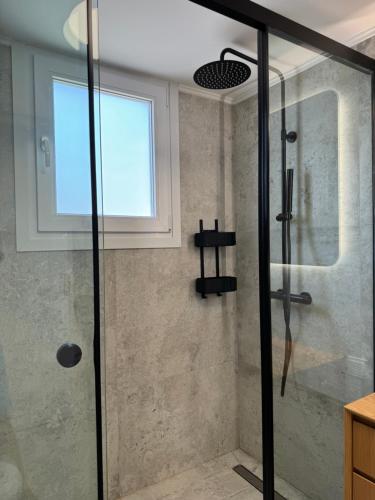 a shower with a glass door in a bathroom at Madi Luxury Stay Patra in Patra