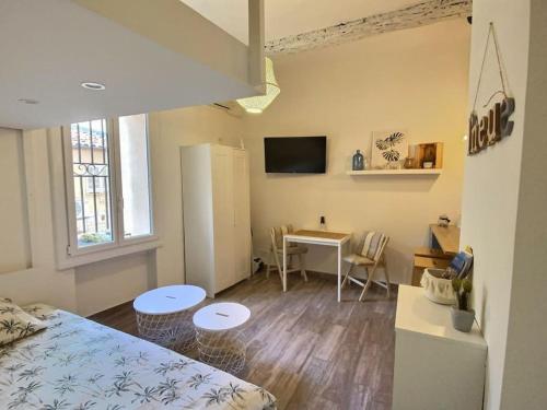 Un dormitorio con una cama y un escritorio en una habitación. en Studio vieil Antibes et mezzanine proche de la mer, en Antibes