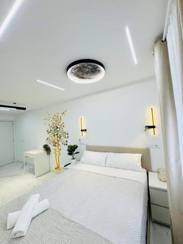a white bedroom with a large white bed in it at Fuenlabrada in Fuenlabrada