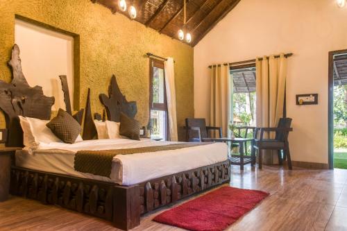 a bedroom with a large bed in a room at Bijrani Jungle Camp by Fairlink in Rāmnagar
