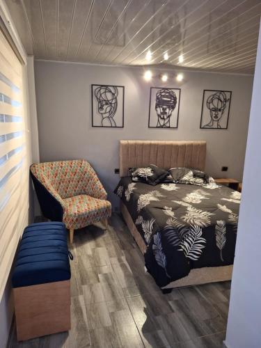 a bedroom with a bed and a chair at Vélez Loft in Vélez