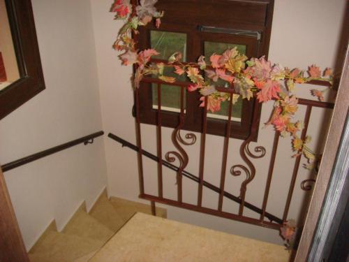 a staircase with a wrought iron railing with a window at Villa Angela in Sikia