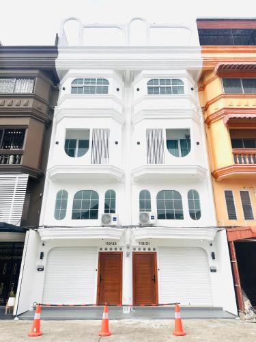 a white building with orange cones in front of it at White House31 EntireHouse & Rooftop DMK Airport & BTS BKK in Ban Sai Mai