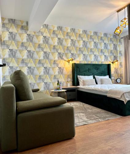 a bedroom with a bed and a chair in it at Anto Apartments in Râşnov