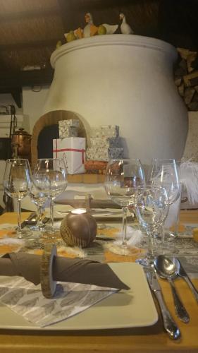 a table with wine glasses and silverware on it at Viktória Inn Tihany in Tihany