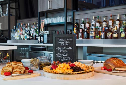 a table with a display of food and bread at Element Waco in Waco