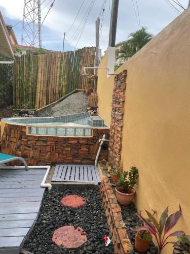 a patio with a bench and a swimming pool at Tropical Harbour View in Monchy