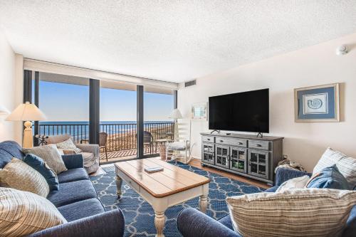 a living room with a couch and a tv at Sea Colony - 604 Dover House Rd. in Bethany Beach