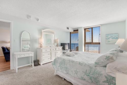 a white bedroom with a bed and a mirror at Sea Colony - 604 Dover House Rd. in Bethany Beach