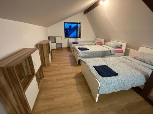a room with three beds and a couch at Großzügiges Apartment am Rhein in Koblenz-Neuendorf in Koblenz