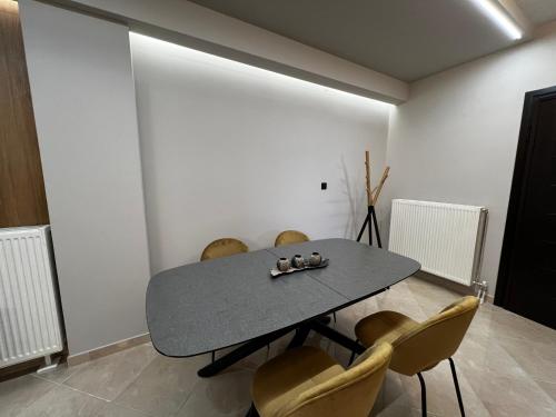 a dining room with a table and chairs at Suite Rooms -Fine Living in Vévi