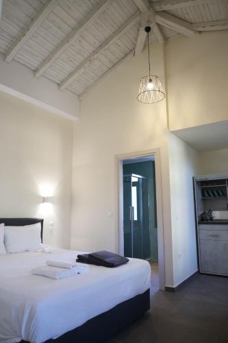 a bedroom with a large white bed with a light at Xenion1850 culture and living in Vrontádos
