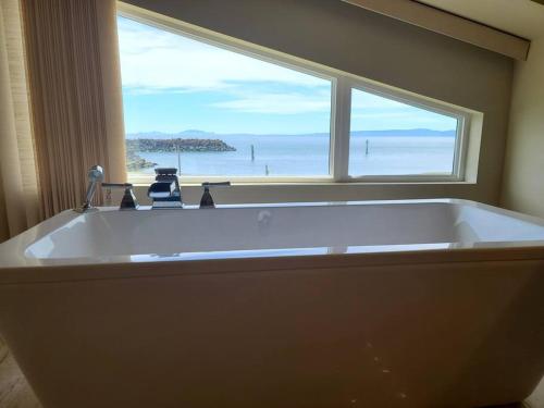 een groot bad met uitzicht op de oceaan bij The Seaside Getaway in Point Roberts