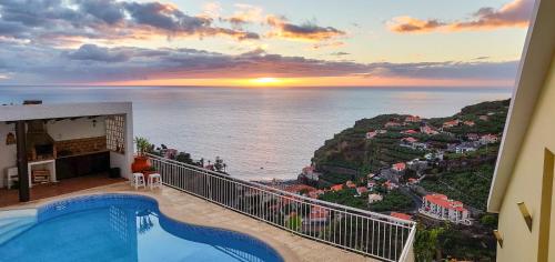 a view of the ocean from the balcony of a house at Villa Margarida in Ponta do Sol