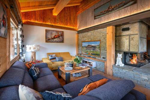 a living room with a couch and a fireplace at Chalet K1027 - OVO Network in Cordon