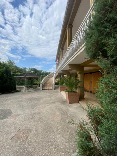 a building with a stairway leading into a courtyard at Giorgi's Guesthouse in K'obulet'i