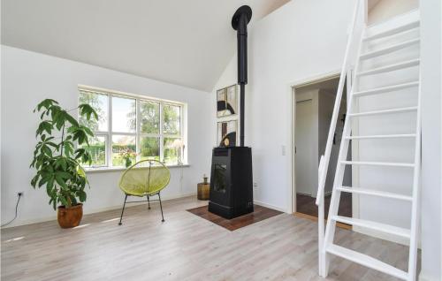 a living room with a staircase and a chair at Luna in Vedelshave