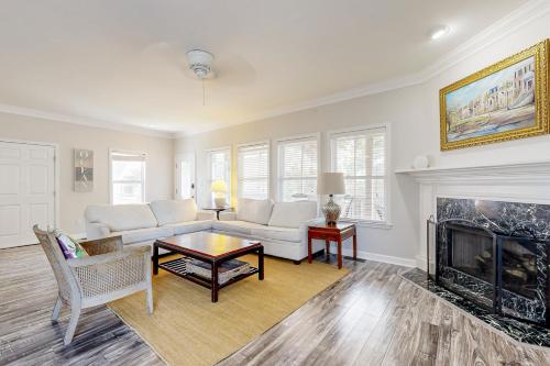 a living room with a couch and a fireplace at Shady Retreat in Tybee Island