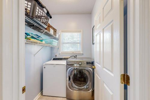 a small laundry room with a washing machine in it at Shady Retreat in Tybee Island