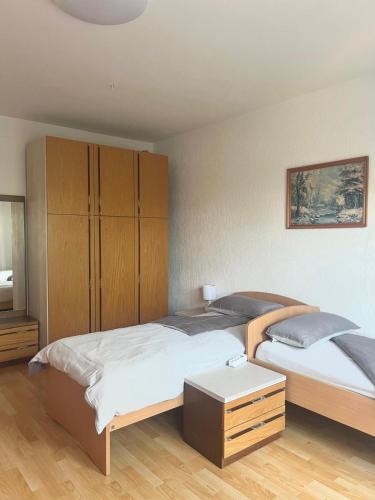 a bedroom with two beds and a cabinet at Apartments Ballabanka in Koper