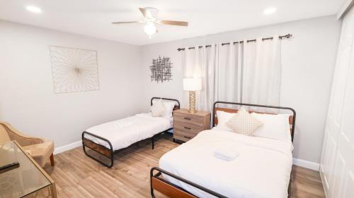 a bedroom with two beds and a ceiling fan at Xlnc Exotic Home Gillespie Drive in Spring Valley