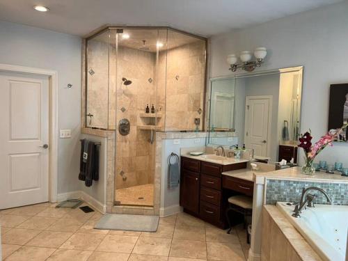 a bathroom with a shower and a sink and a tub at The Big House on Pleasant Valley Farm in Columbia
