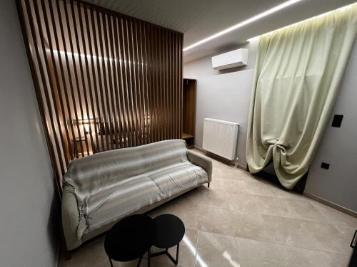 a room with a couch and two chairs in it at Suite Rooms -Fine Living in Vévi