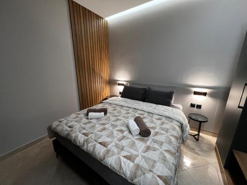 a bedroom with a large bed with two pillows on it at Suite Rooms -Fine Living in Vévi