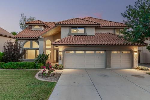 a house with a garage in front of it at Elegant Luxury Villa Wheated Pool Outdoor Fun in Chandler