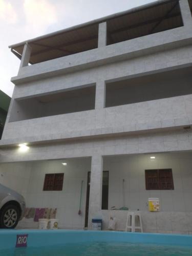 a house with a car parked in front of it at Casa Praia BRISAMAR in Maragogi