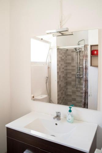 a bathroom with a sink and a mirror at Front House in Lisbon