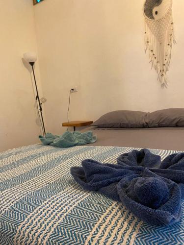a bed with blue towels laying on the floor at Caribbean Retreats in Cocles