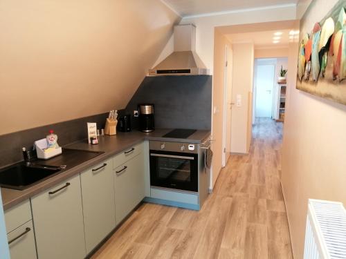a kitchen with a sink and a stove at May Home in Schashagen