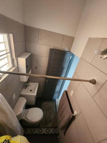 a small bathroom with a toilet and a sink at Catano Bay Apartment in Catano