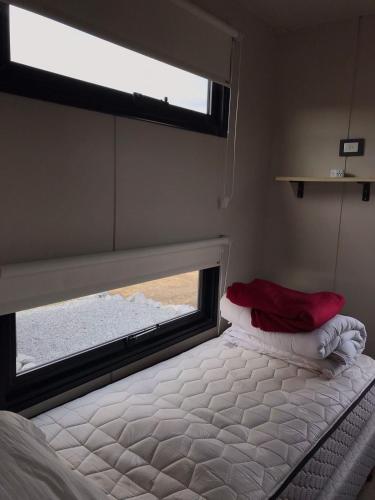 a bed in a small room with a window at Posada de los topos in Tandil