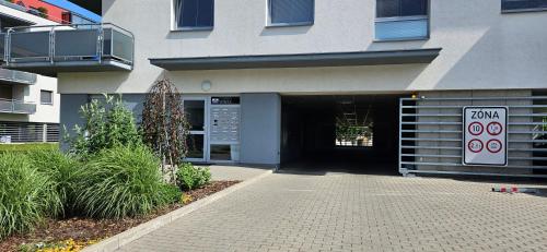 a entrance to a building with a parking garage at Apartment Holata 401 in Hradec Králové
