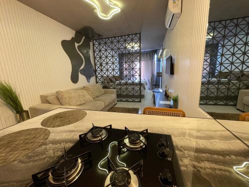 a room with a bed and a living room at Link Araranguá in Araranguá