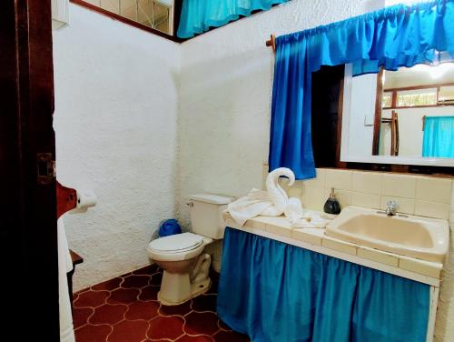 a bathroom with a toilet and a sink at Maya Mountain Lodge in San Ignacio
