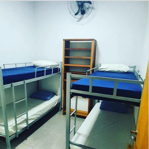 a room with three bunk beds in a room at HOTEL POUSADA SÃO PEDRO MATÃO in Matão