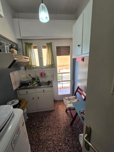 a small kitchen with a sink and a counter at loutraki apartment in Loutraki