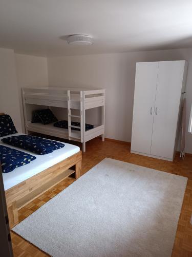 a bedroom with a bunk bed and a white cabinet at Mon Amour Apartment in Interlaken