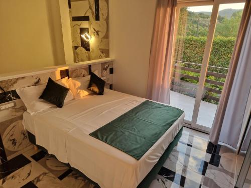 a bedroom with a bed and a large window at B&B Artemide in Agropoli