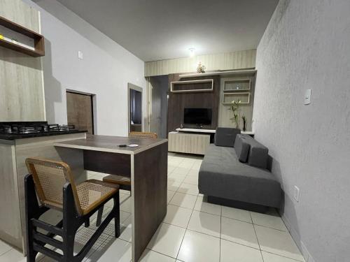 a kitchen and living room with a couch and a table at Link Araranguá in Araranguá